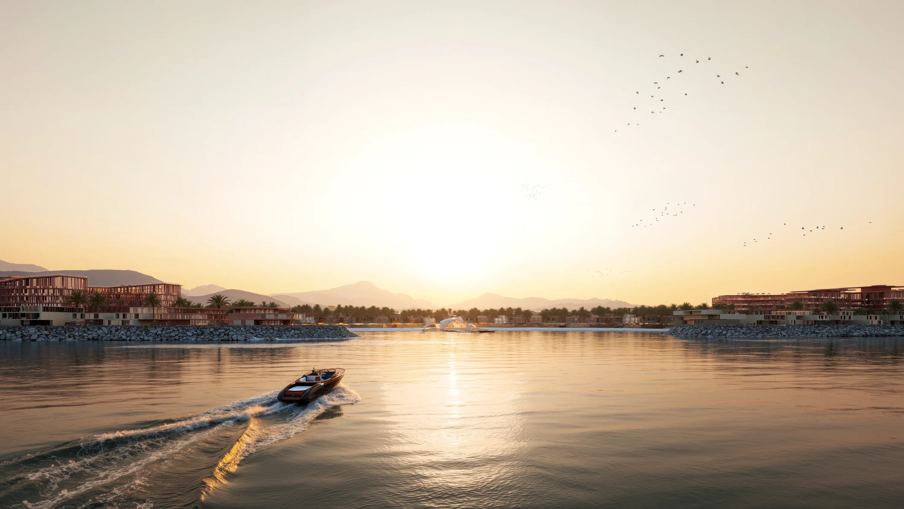 The bay at Mira Coral Bay at sunset, the Hajar mountains behind the shoreline