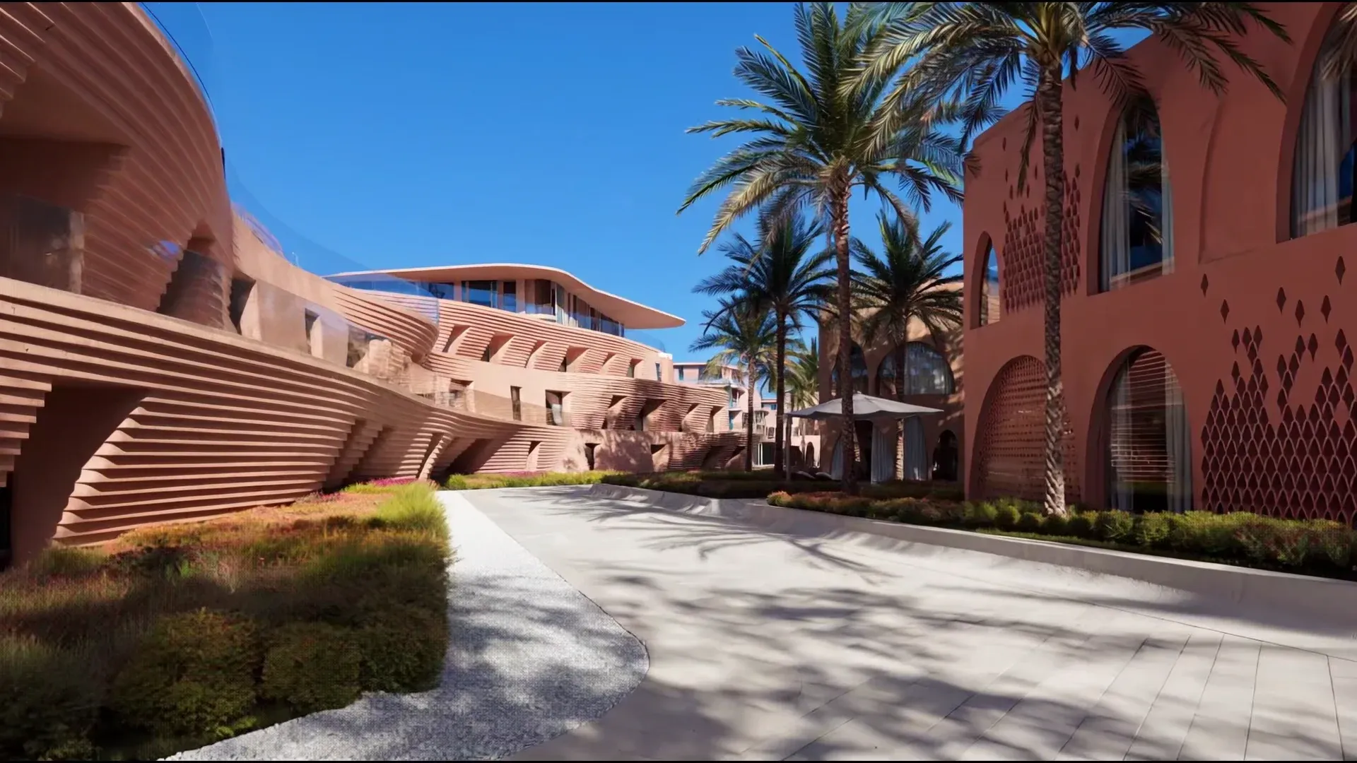 A palm-lined boulevard between the curved coral facades of Mira Coral Bay