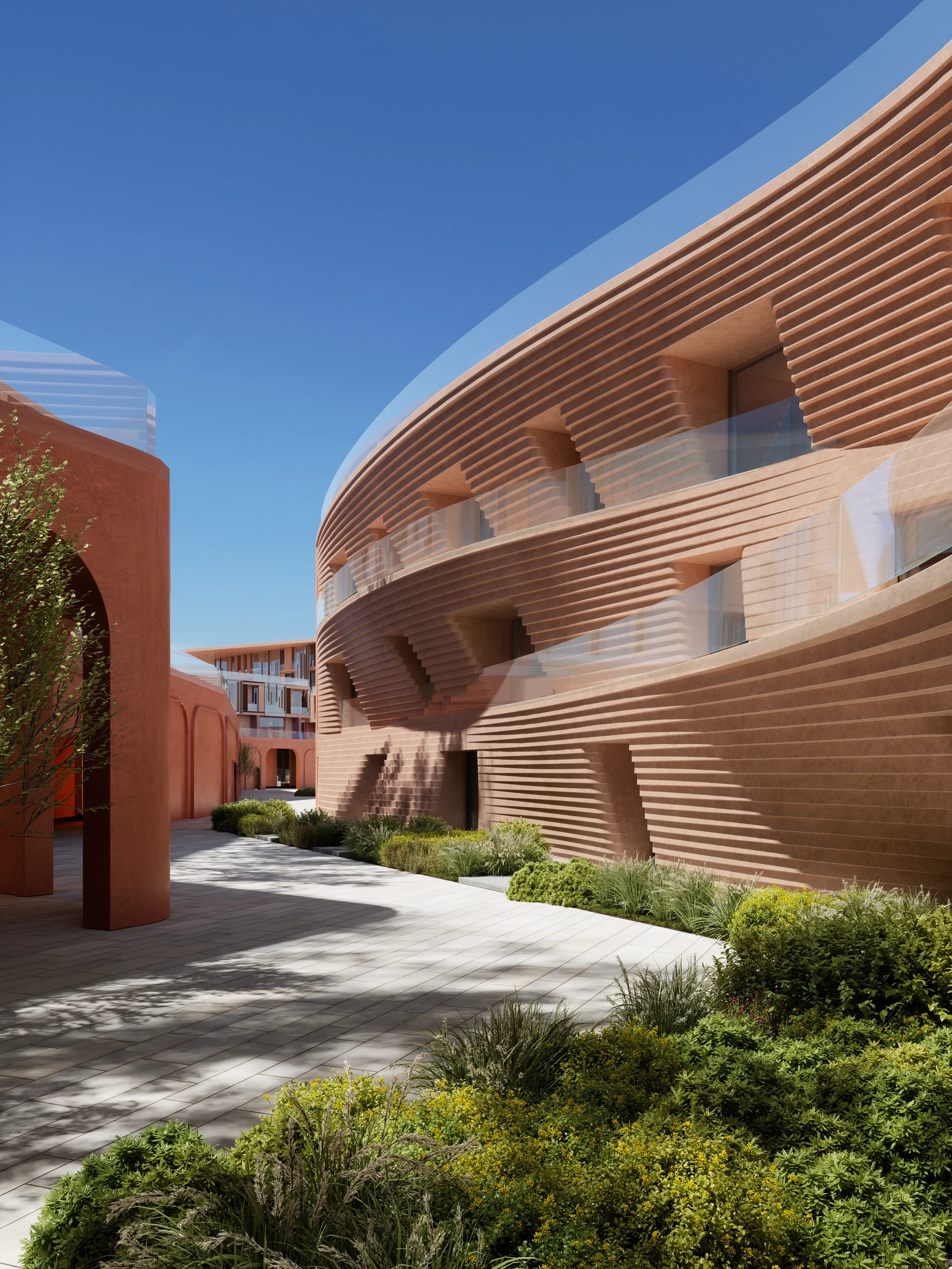 Curved podium facades around a planted courtyard at Mira Coral Bay